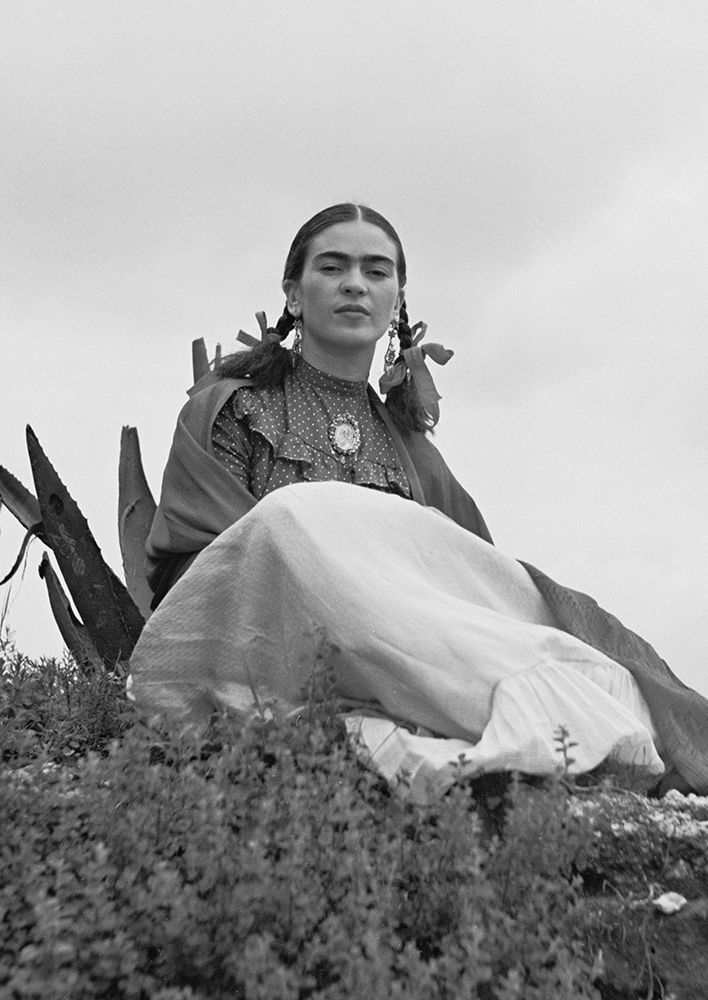 Frida Kahlo seated in the desert