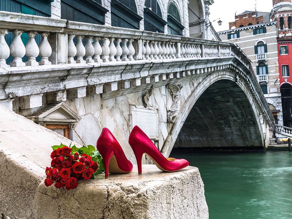 Bunch of red roses and red high heel shoes, Rialto Bridge, Venice, Italy