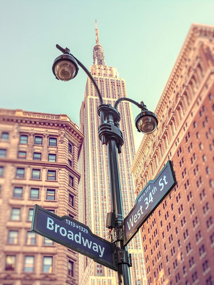 Street lamp and street signs with Empire State building in background - New York
