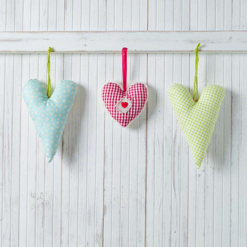 Hearts hanging on wooden background