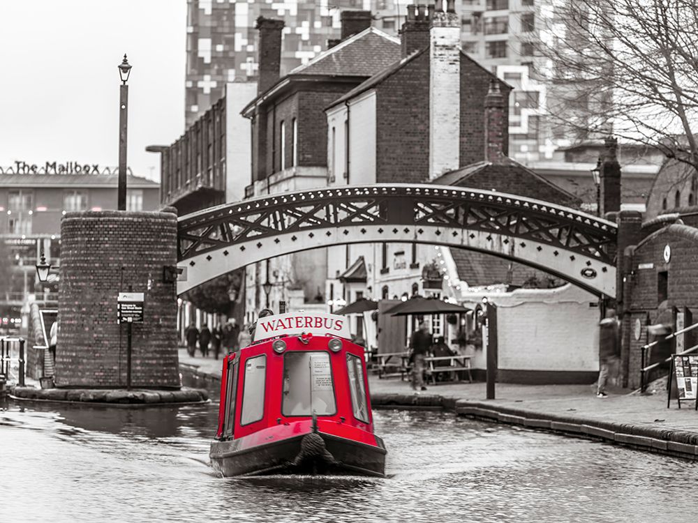 Narrow canal with small boats in Birmingham, UK