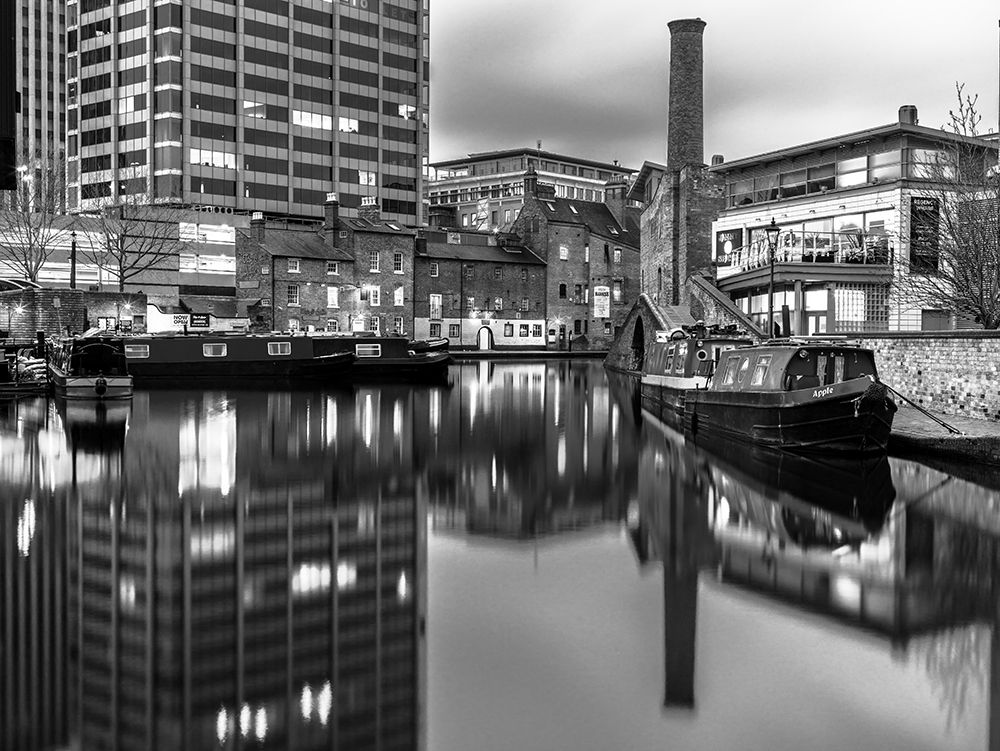 Narrow canal with small boats in Birmingham, UK