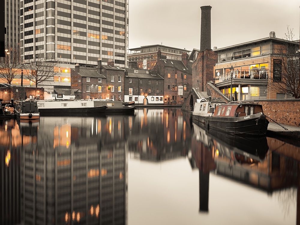 Narrow canal with small boats in Birmingham, UK