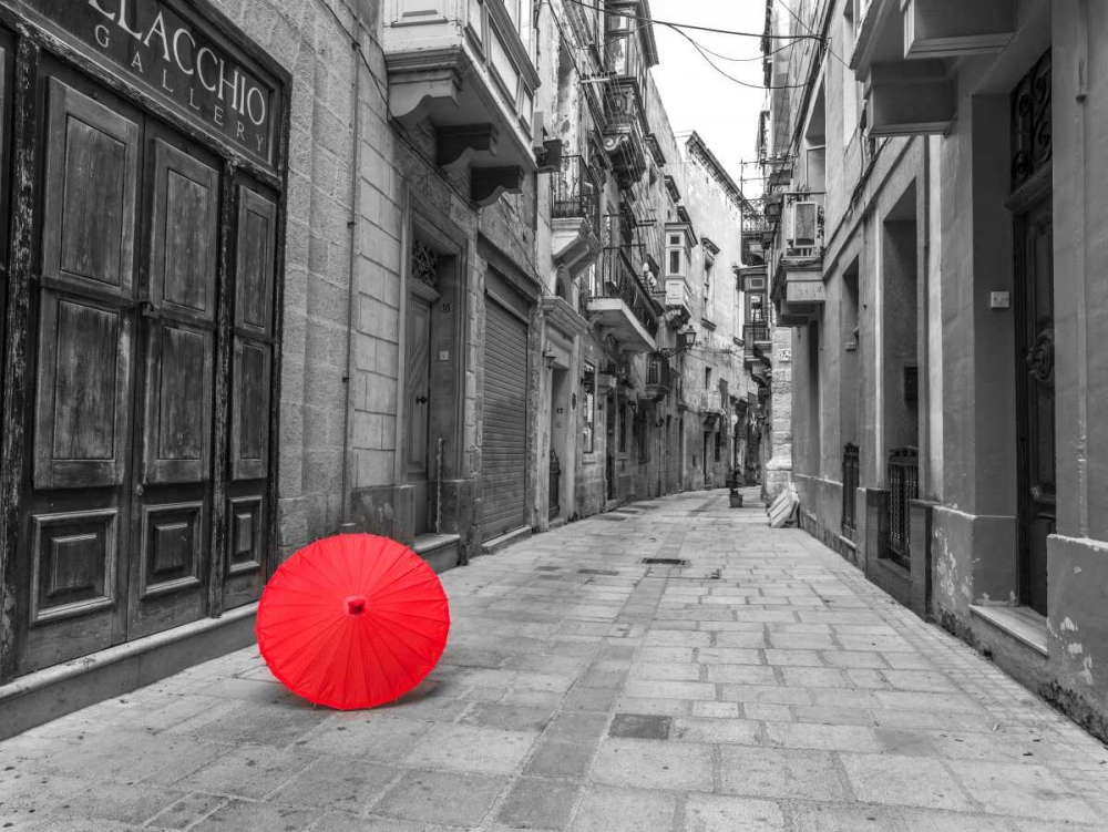 Red umbrella on narrow street of Birgu, malta