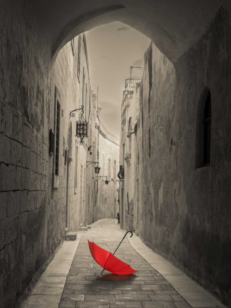 Red umbrella on narrow street of Mdina, Malta