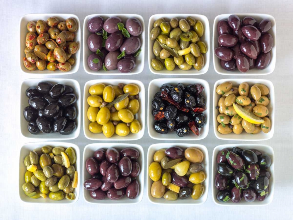 Varieties of Olives in bowls on white background