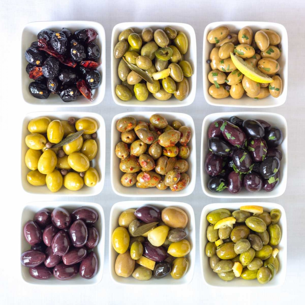 Varieties of Olives in bowls on white background
