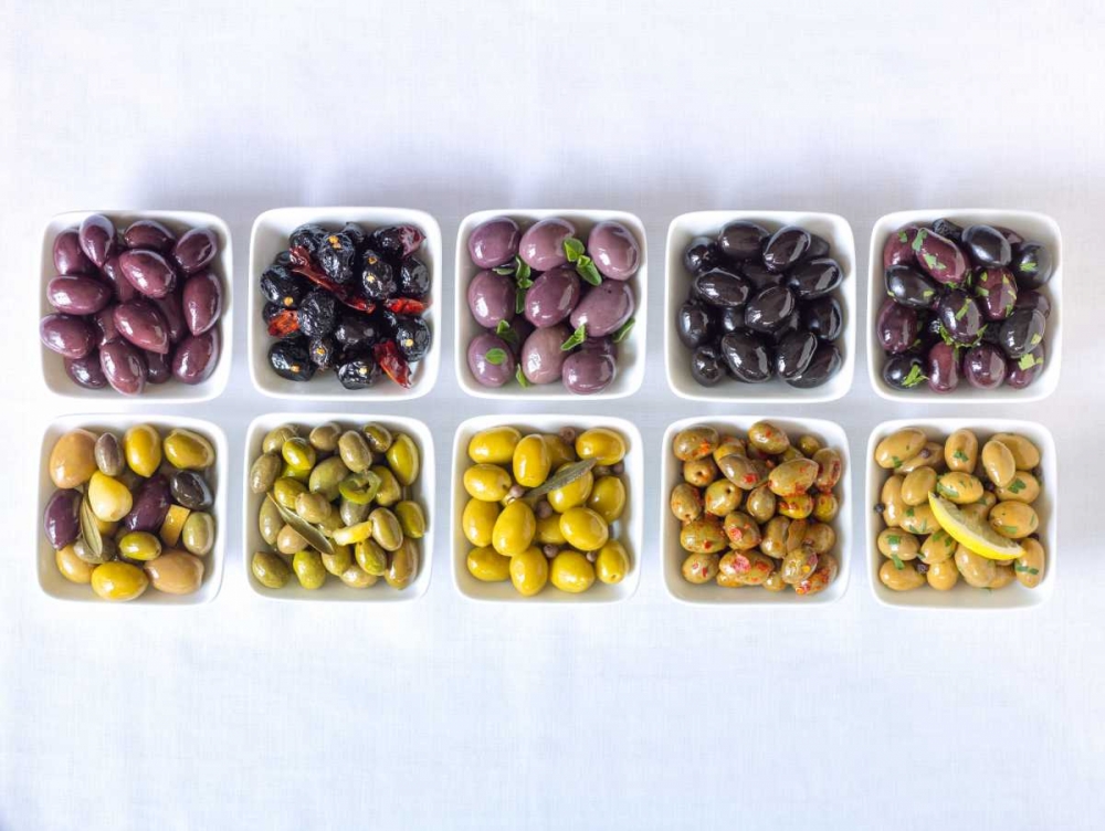 Varieties of Olives in bowls on white background