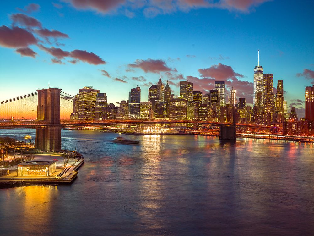 Evening view of Lower Manhattan skyline with Brooklyn bridge over East river, New York