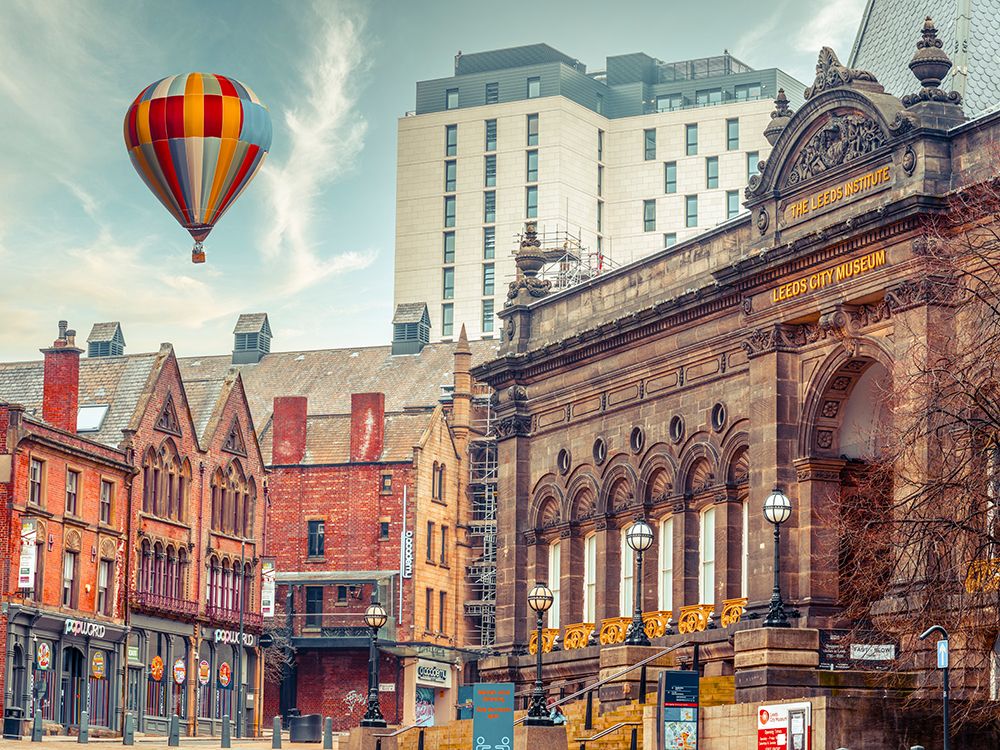 Hot air balloon over Leeds cityscape