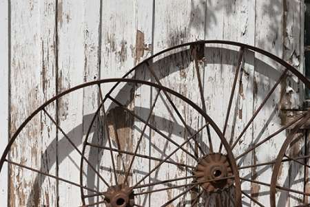 Old wagon wheels against a shed in Buffalo Gap Historic Village, near Abilene, TX