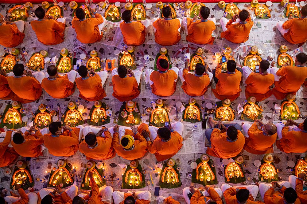 Devotees pray with light