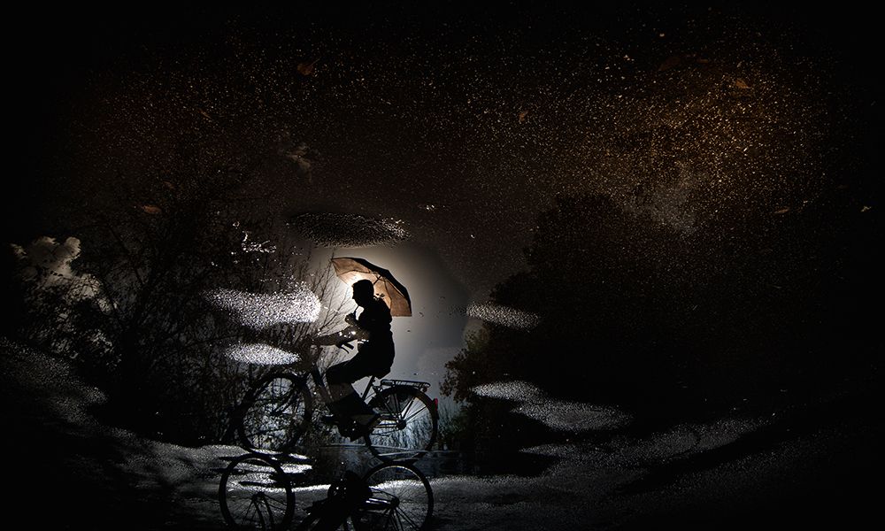 Pedaling by bicycle...