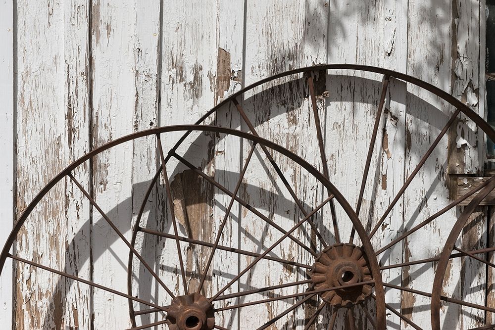 Old wagon wheels against a shed in Buffalo Gap Historic Village, near Abilene, TX