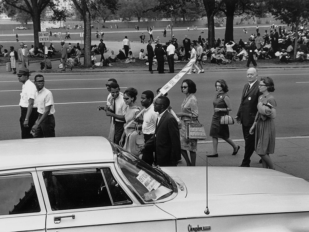 Civil RightsÂ MarchÂ onÂ Washington-D.C. Marchers walking and sitting under the trees