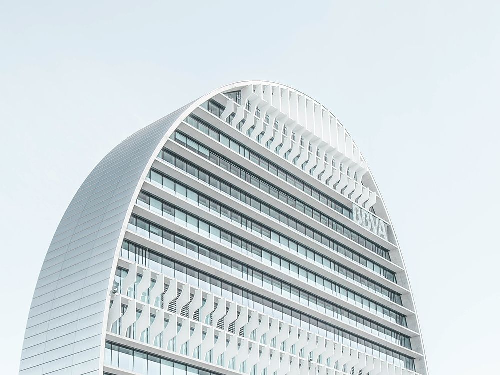 A modern skyscraper with a rounded roof in Madrid