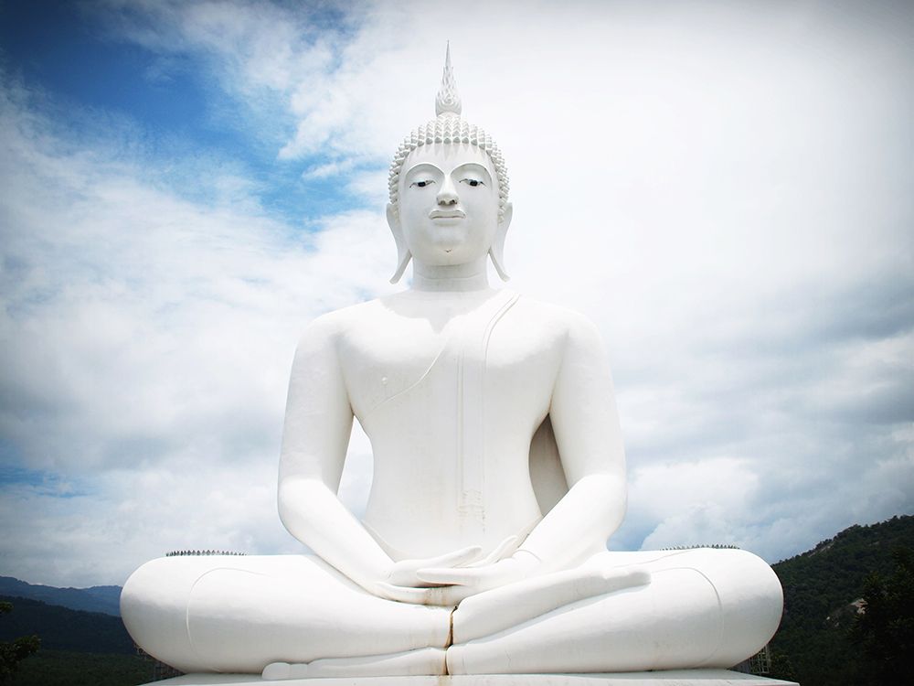 White Buddha Statue with Clouds
