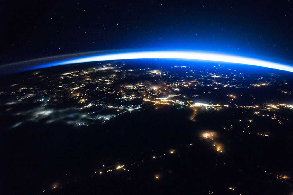Night image of a Sliver of Daylight Framing the Northern Hemisphere