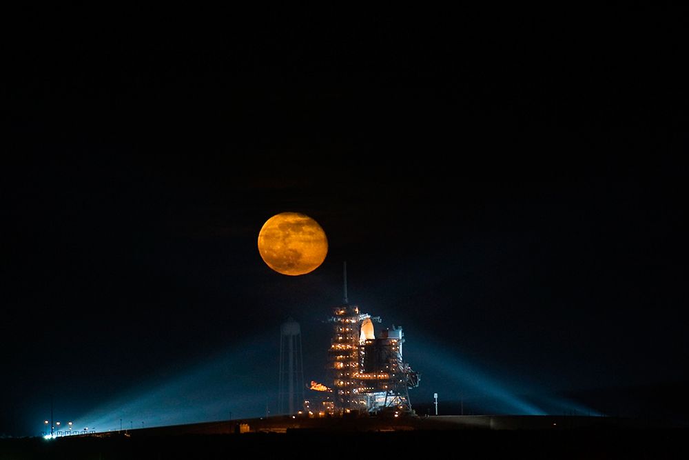 The Moon Rising behind the Space Shuttle Endeavour on pad 39A